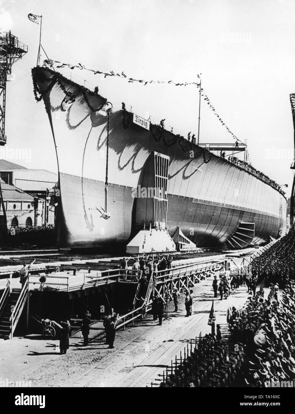 The picture shows the celebrations on the occasion of the launching of the 'Tirpitz', a battleship of the 'Bismarck class' of the Kriegsmarine. Soldiers, party members, civilians and workers have all appeared at the ceremony, which was also attended by Adolf Hitler. Stock Photo