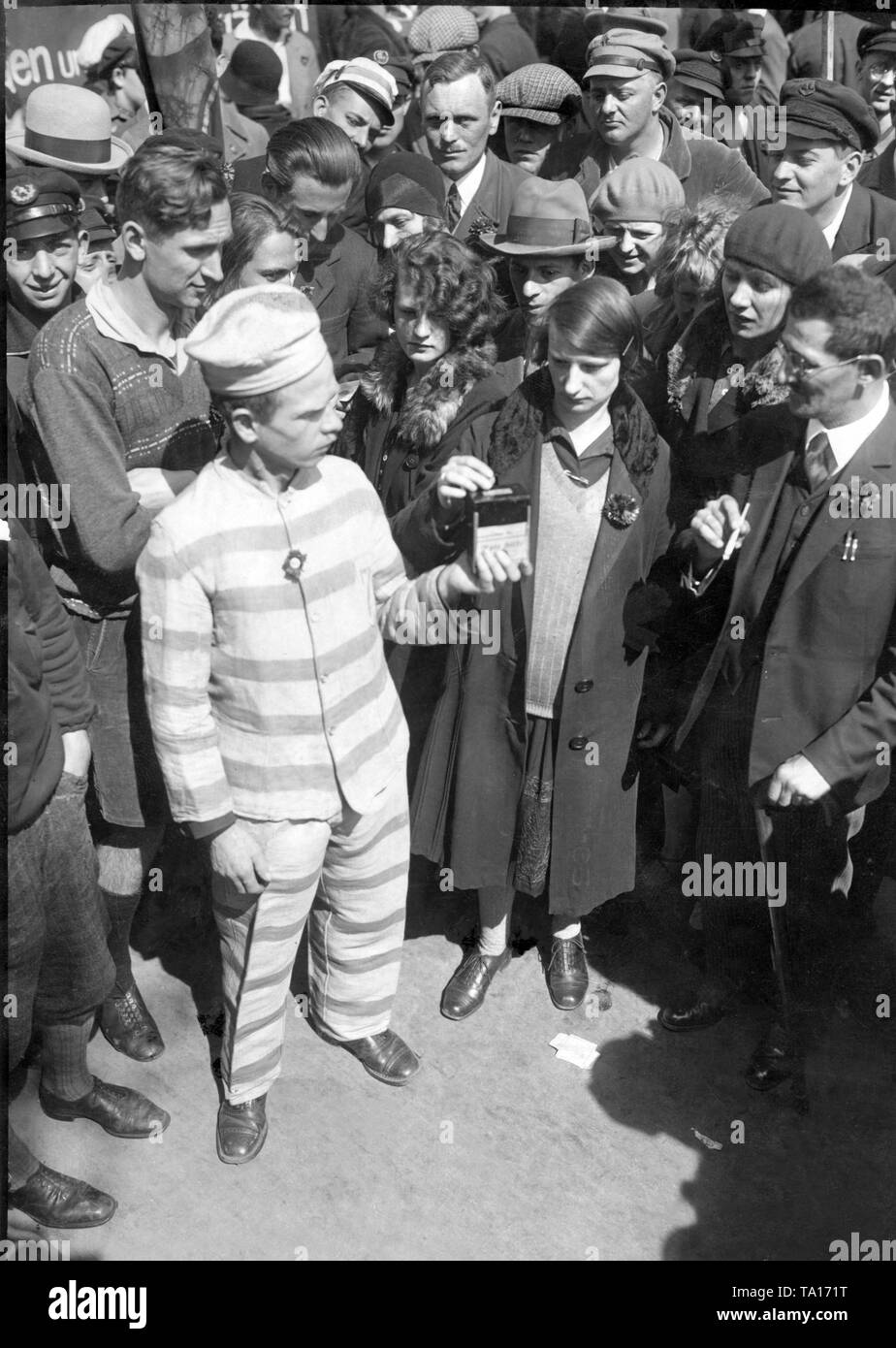 Communists in convict uniforms collect funds for the Rote Hilfe  at the May Day celebration in Berlin. Stock Photo