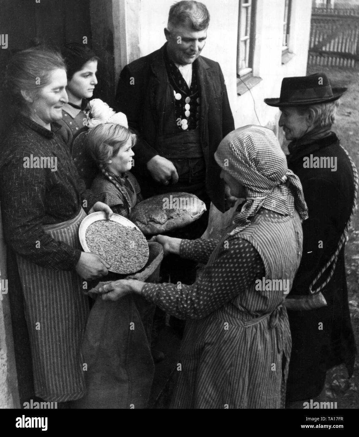 As part of a donation campaign of the Nazi Winterhilfswerk, farmers donate food to village residents. (Undated photo) Stock Photo