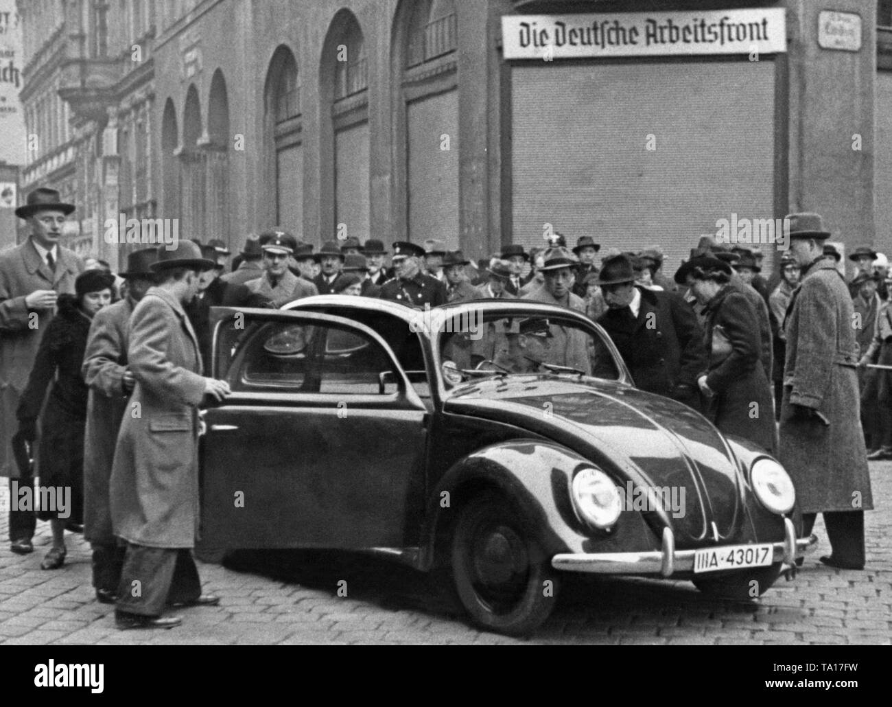 A prototype of the 'KdF Wagen' is presented to the surrounding audience in the Schottenfeldgasse in Vienna. Stock Photo