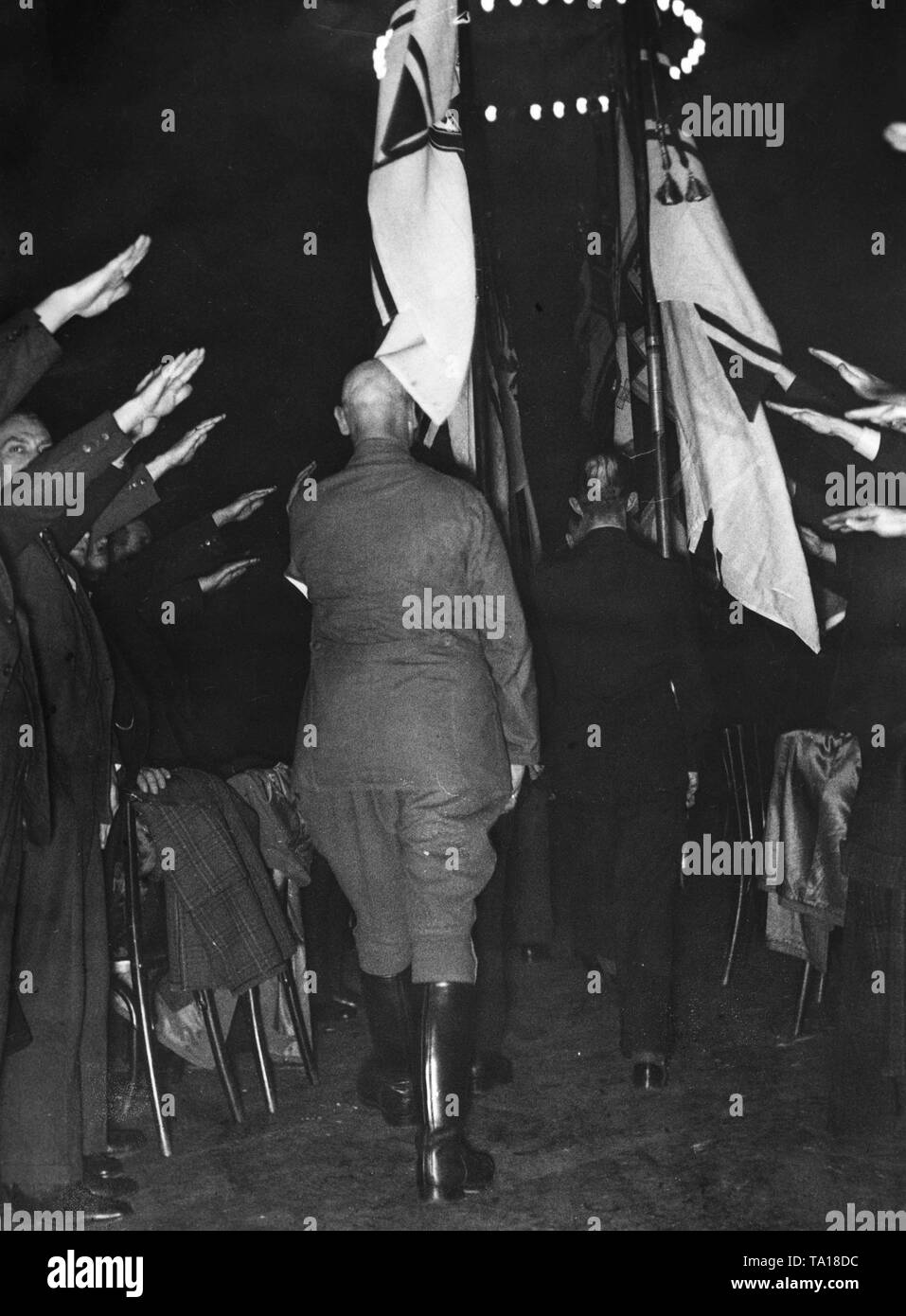 After the dissolution of the Stahlhelm, a last farewell roll call took place in the Krieger-Vereinshaus. Here, members marching with the flags under the Hitler salute. Stock Photo