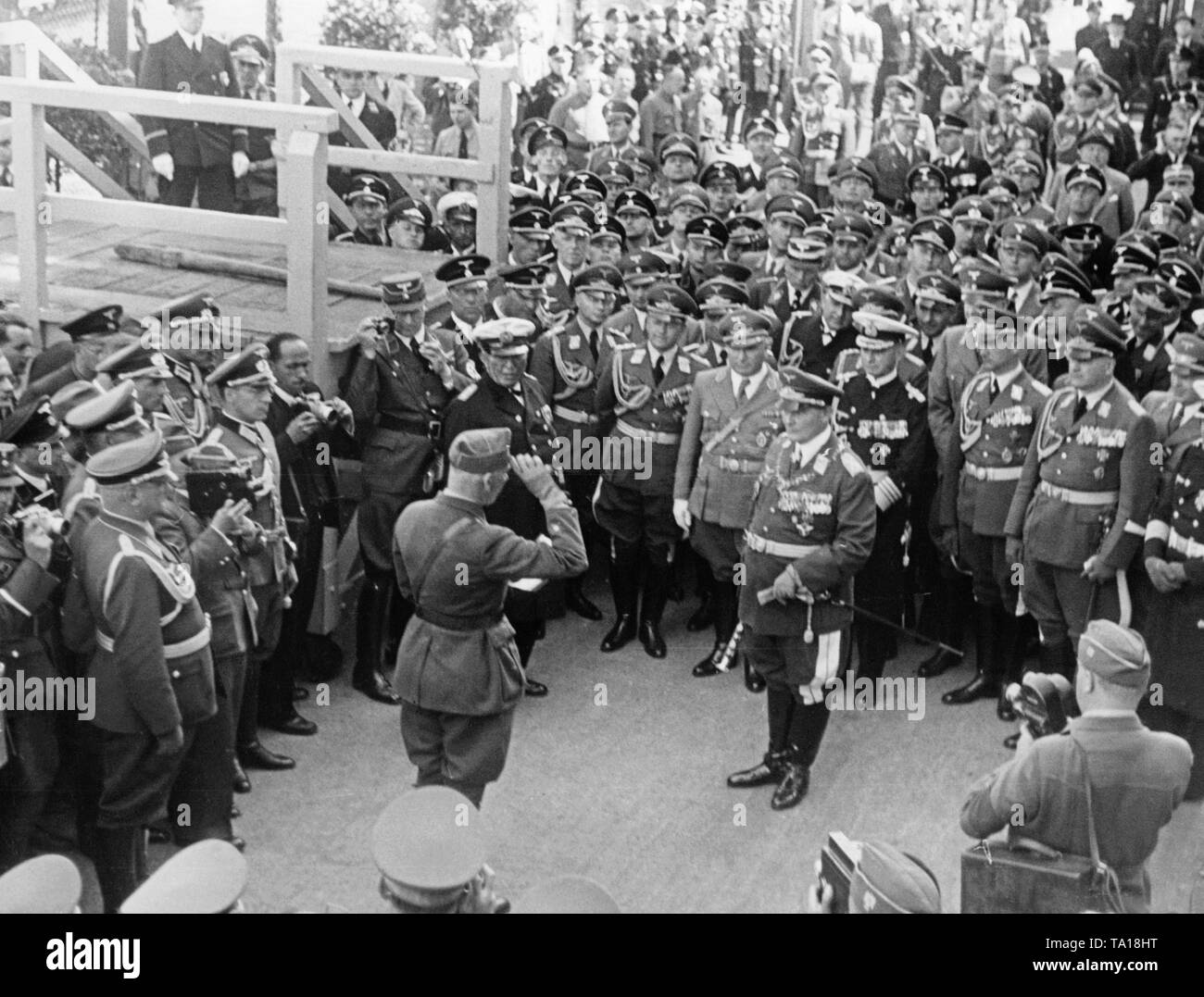 Field Marshal General Hermann Goering, welcomes the commander of the Condor Legion, Major General Wolfram von Richthofen (left, saluting) on the occasion of their return from Spain ton the gangway of the Port of Hamburg in the district of St. Pauli. In the first row, Colonel-General Erhard Milch, Robert Ley and General Admiral Conrad Albrecht, as well as prominent figures of the military. Stock Photo