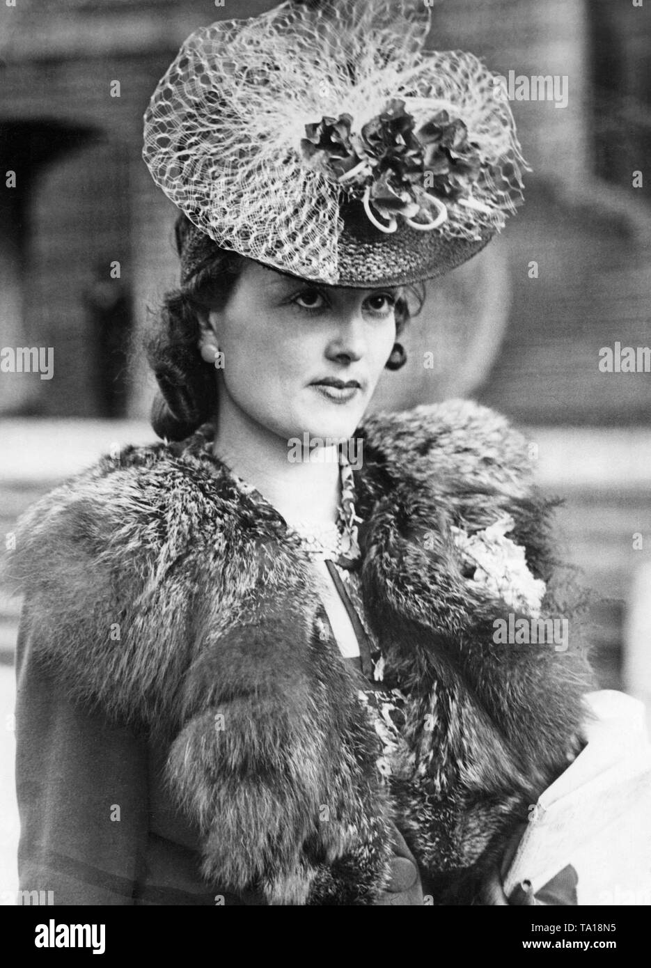 The model wears a decorated hat from the spring collection 1939 at the reopening of the race track at Auteuil. Stock Photo