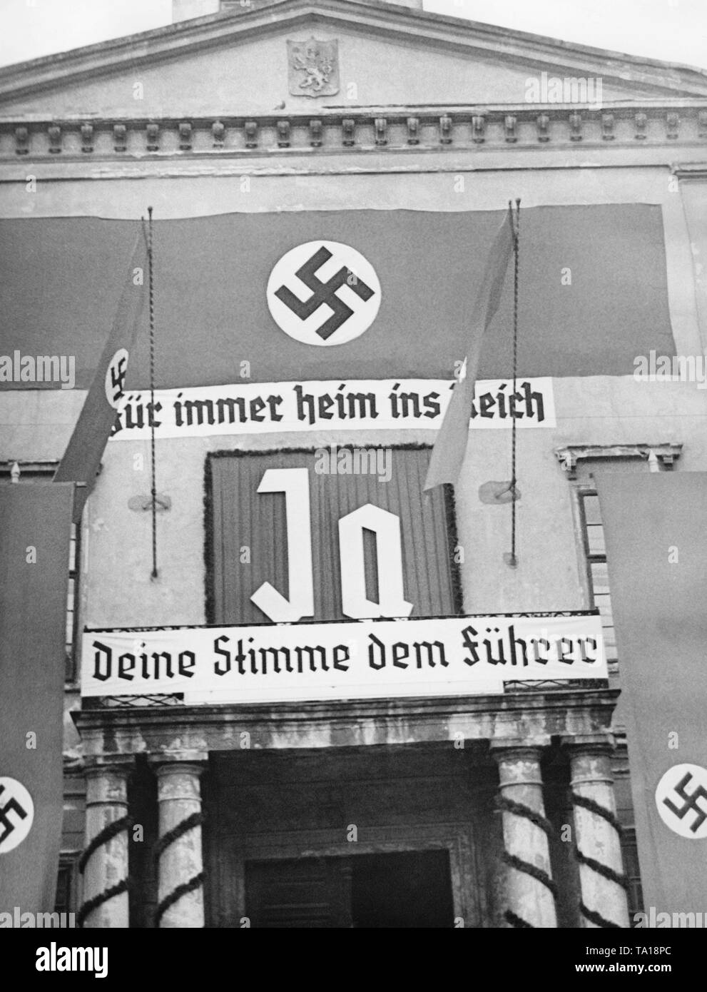 The exhibition hall in Reichenberg (today Liberec) is festively decorated for the upcoming Sudeten German by-elections. The Sudeten Germans decide, whether the Sudetenland should be annexed to the German Reich. On the poster: 'Forever at home in the Reich', 'Yes' and 'Vote for the Fuehrer'. Stock Photo