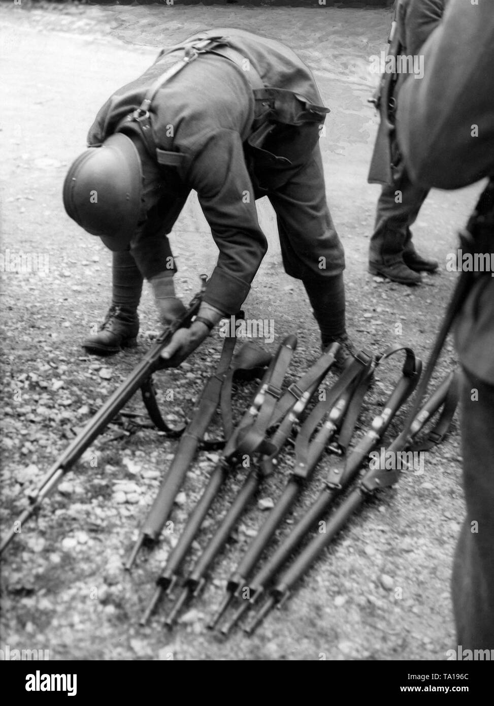 A French soldier unloads his Lebel Model 1886 rifle. Stock Photo