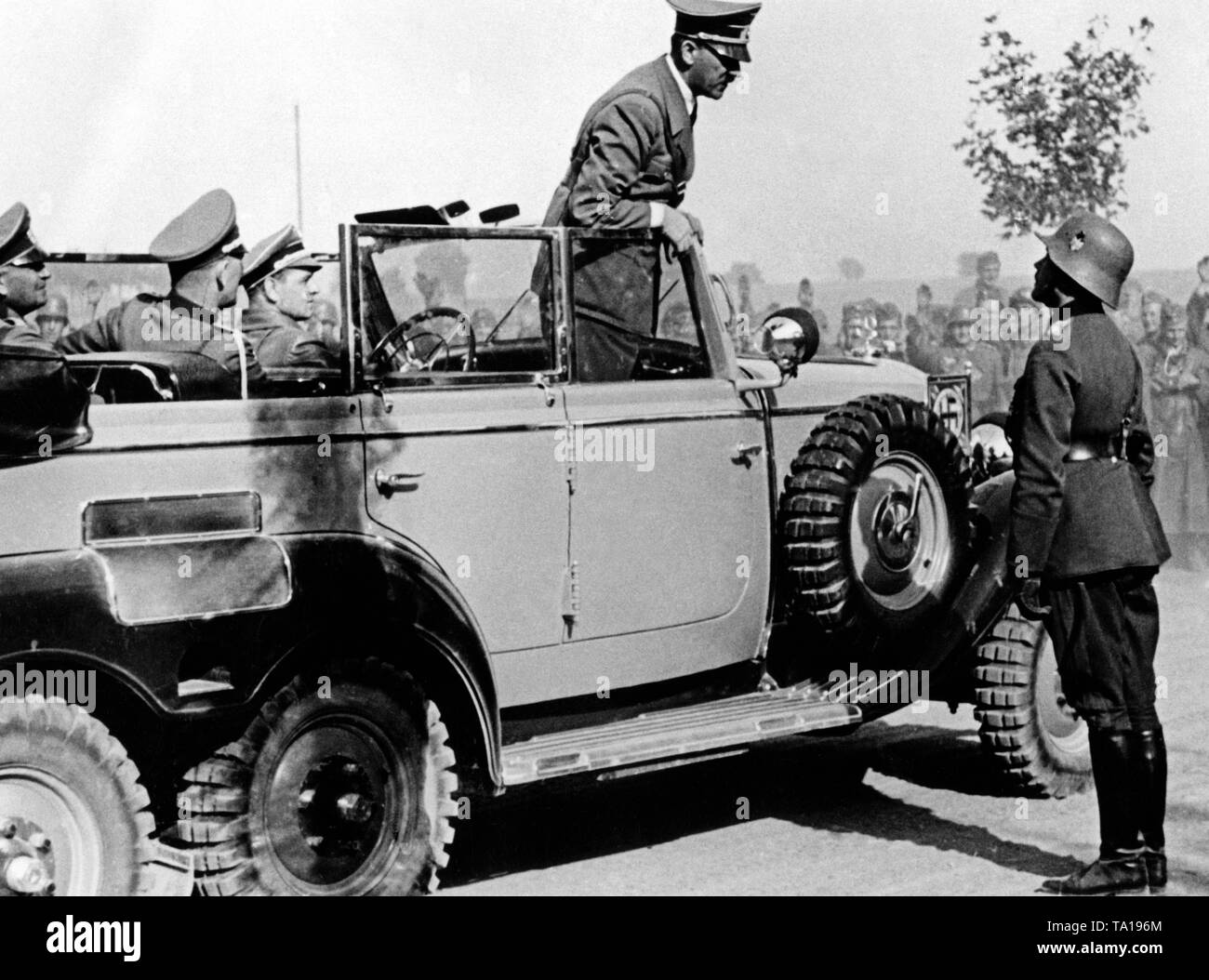 Adolf Hitler in a Mercedes G4 at Plewno in Poland. Next to the car is Heinz Guderian, General of the Armoured Troops. At the wheel, the driver Kempka. Stock Photo