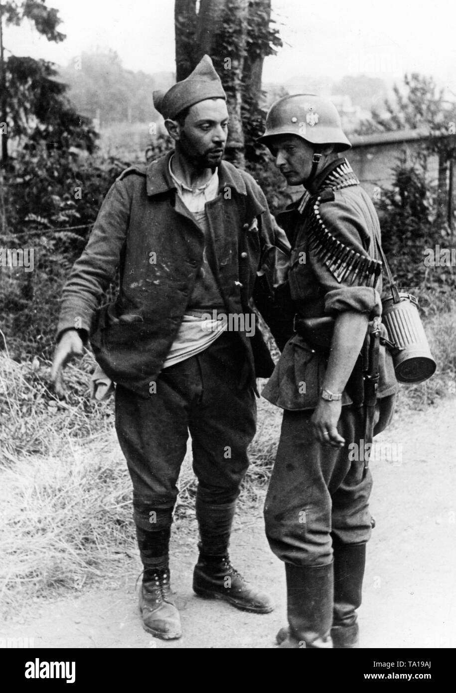 A German infantryman talks to a French prisoner. Photo: v.d. Becke Stock Photo