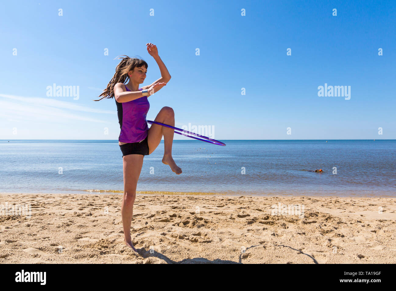 Southbourne, Bournemouth, Dorset, UK. 21st May 2019. UK weather: lovely warm sunny morning as Lottie Lucid performs her hula hooping routine on the beach at Southbourne, enjoying the warm sunny weather in her hot pants. Credit: Carolyn Jenkins/Alamy Live News Stock Photo