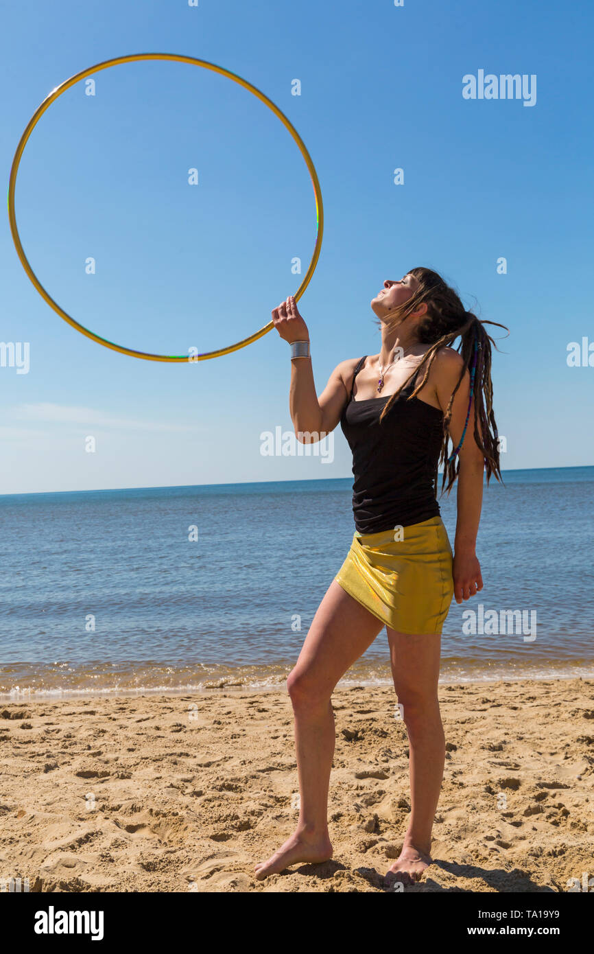 Southbourne, Bournemouth, Dorset, UK. 21st May 2019. UK weather: lovely warm sunny morning as Lottie Lucid performs her hula hooping routine on the beach at Southbourne, enjoying the warm sunny weather in her mini skirt. Credit: Carolyn Jenkins/Alamy Live News Stock Photo