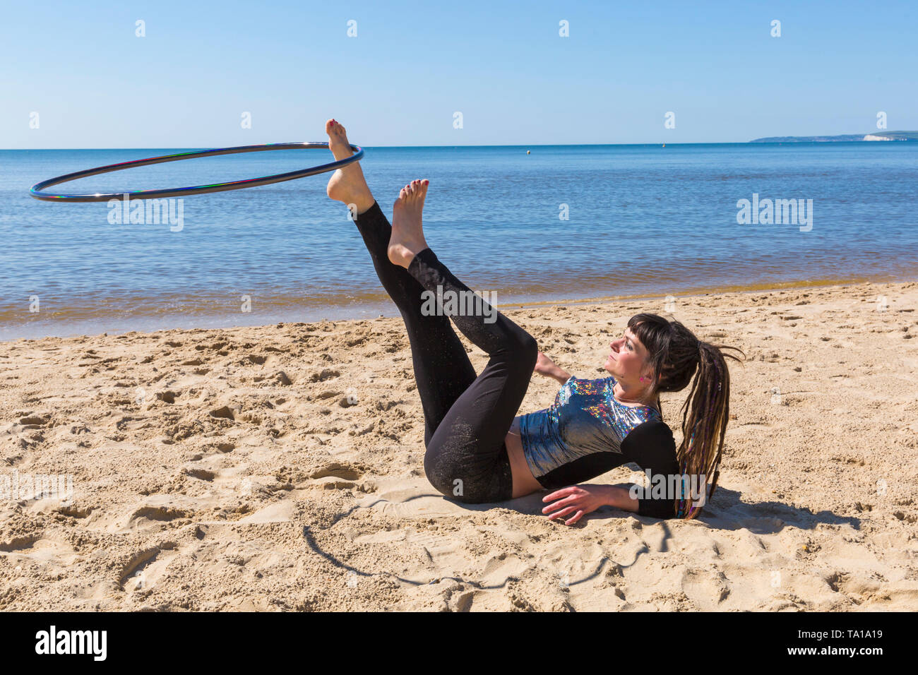 Southbourne, Bournemouth, Dorset, UK. 21st May 2019. UK weather: lovely warm sunny morning as Lottie Lucid performs her hula hooping routine on the beach at Southbourne, enjoying the warm sunny weather. Credit: Carolyn Jenkins/Alamy Live News Stock Photo