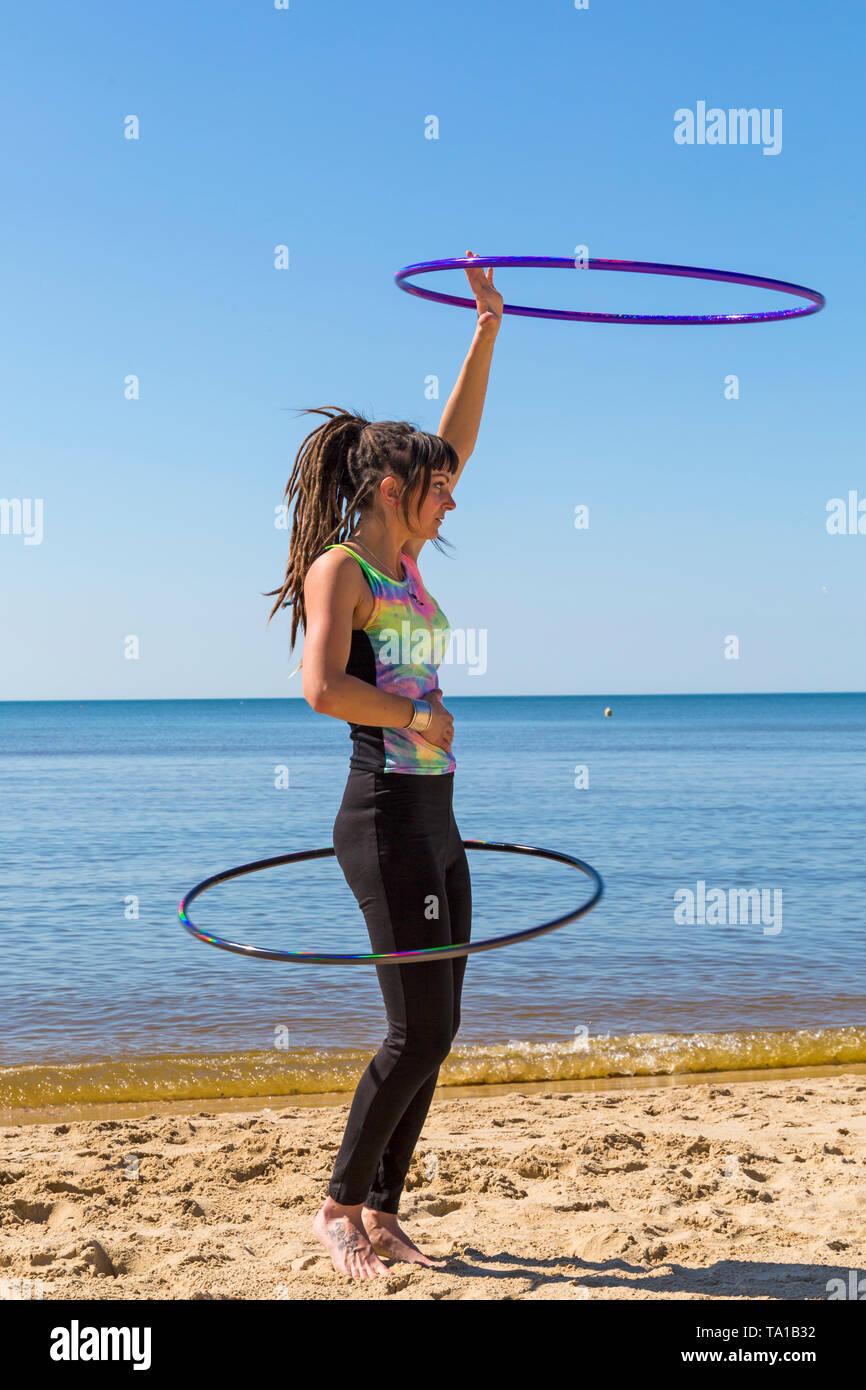 Southbourne, Bournemouth, Dorset, UK. 21st May 2019. UK weather: lovely warm sunny morning as Lottie Lucid performs her hula hooping routine on the beach at Southbourne, enjoying the warm sunny weather. Credit: Carolyn Jenkins/Alamy Live News Stock Photo