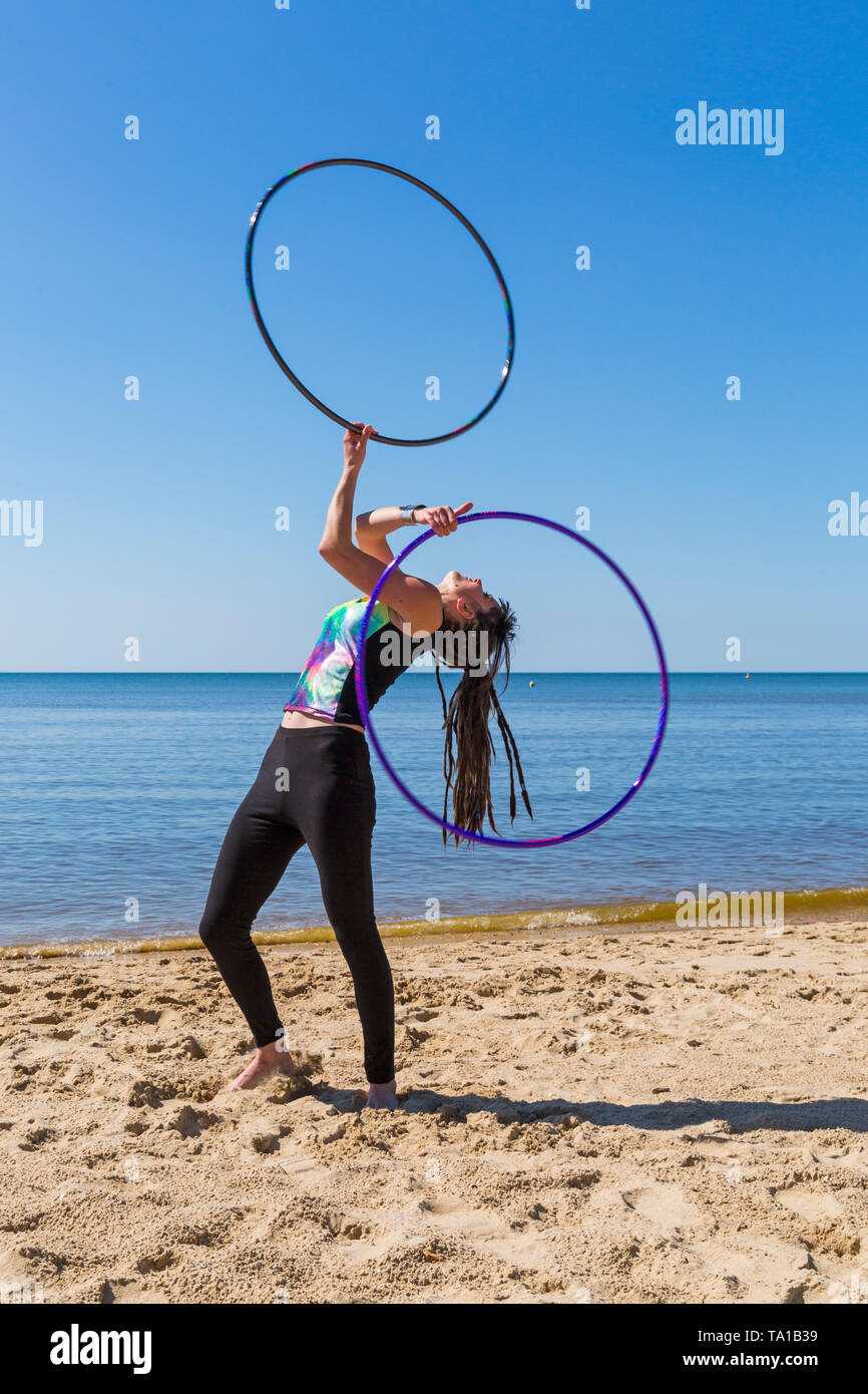 Southbourne, Bournemouth, Dorset, UK. 21st May 2019. UK weather: lovely warm sunny morning as Lottie Lucid performs her hula hooping routine on the beach at Southbourne, enjoying the warm sunny weather. Credit: Carolyn Jenkins/Alamy Live News Stock Photo