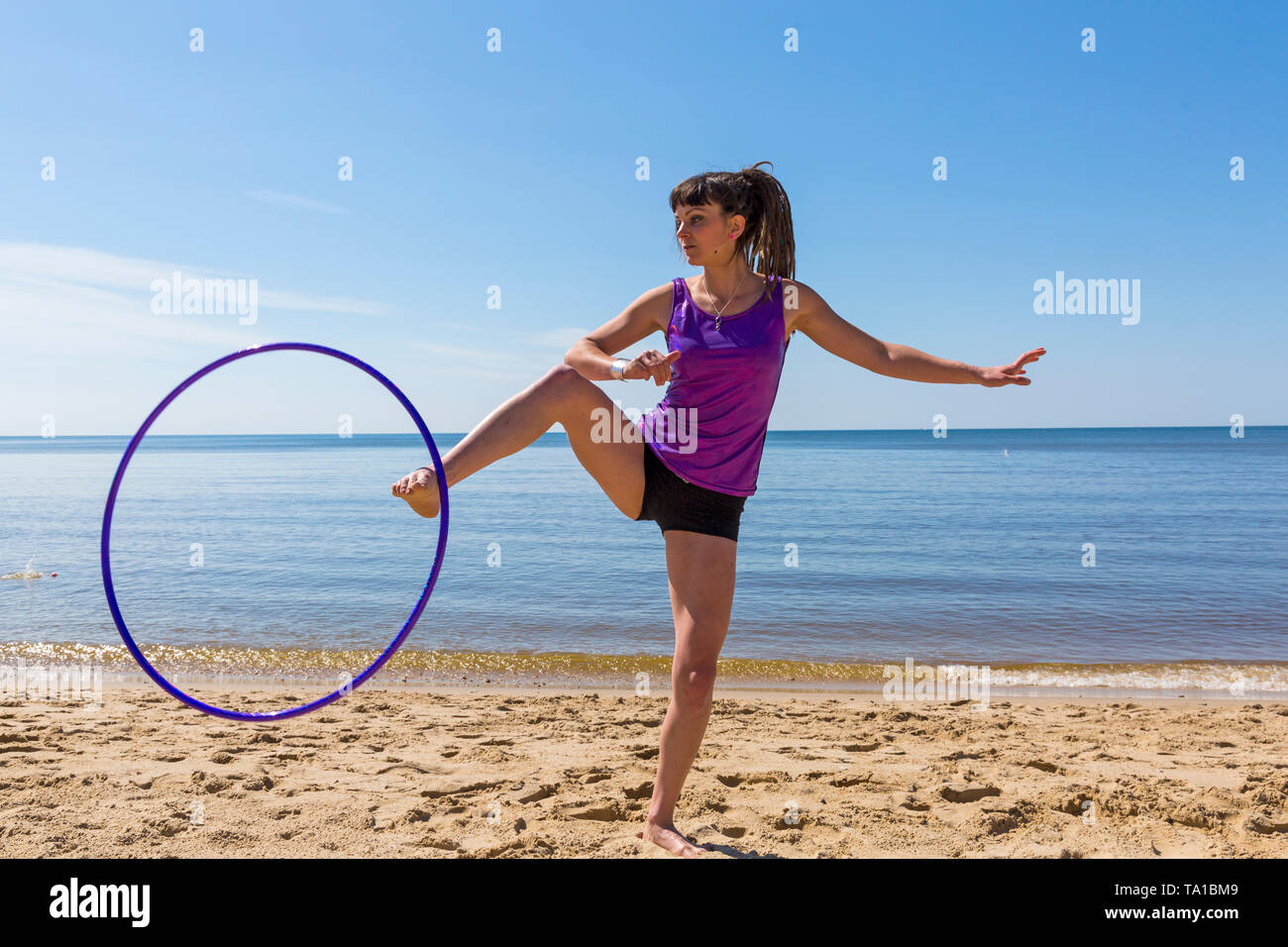 Southbourne, Bournemouth, Dorset, UK. 21st May 2019. UK weather: lovely warm sunny morning as Lottie Lucid performs her hula hooping routine on the beach at Southbourne, enjoying the warm sunny weather in her hot pants. Credit: Carolyn Jenkins/Alamy Live News Stock Photo