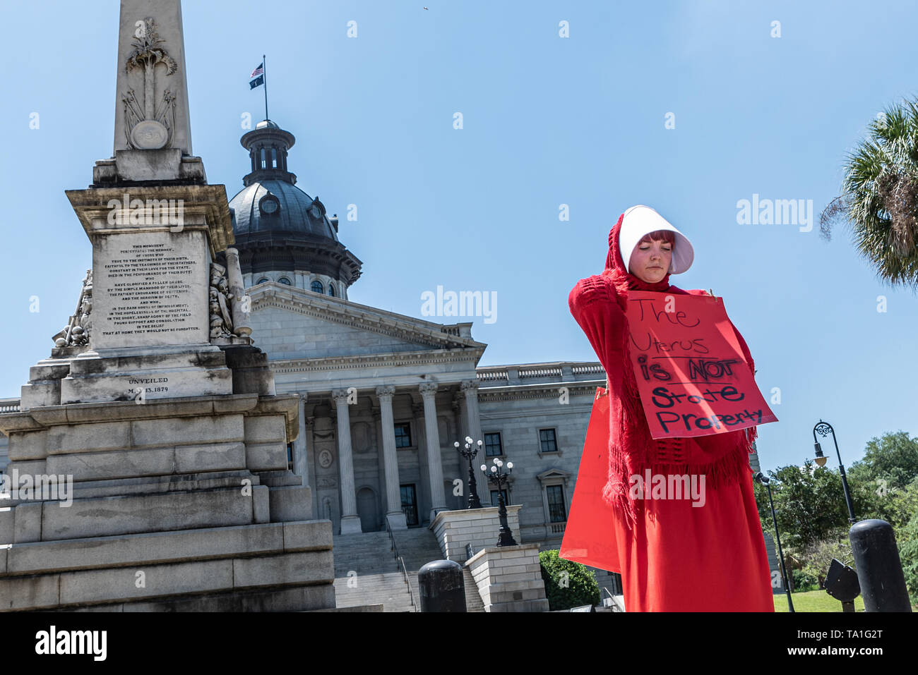 Columbia South Carolina Usa May 21 2019 Activist R M Wears A Costume Outfit That Resembles That Of The Characters From The Show The Handsmaid S Tale While Holding A Sign That Reads