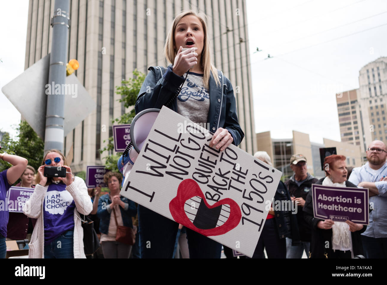 An activist seen chanting slogans on a megaphone while holding a placard that says I will not go quietly back to the 1960s during the protest. Abortion rights activists took part in stop the bans rally nationwide after multiple states pass fetal heartbeat bills. Stock Photo