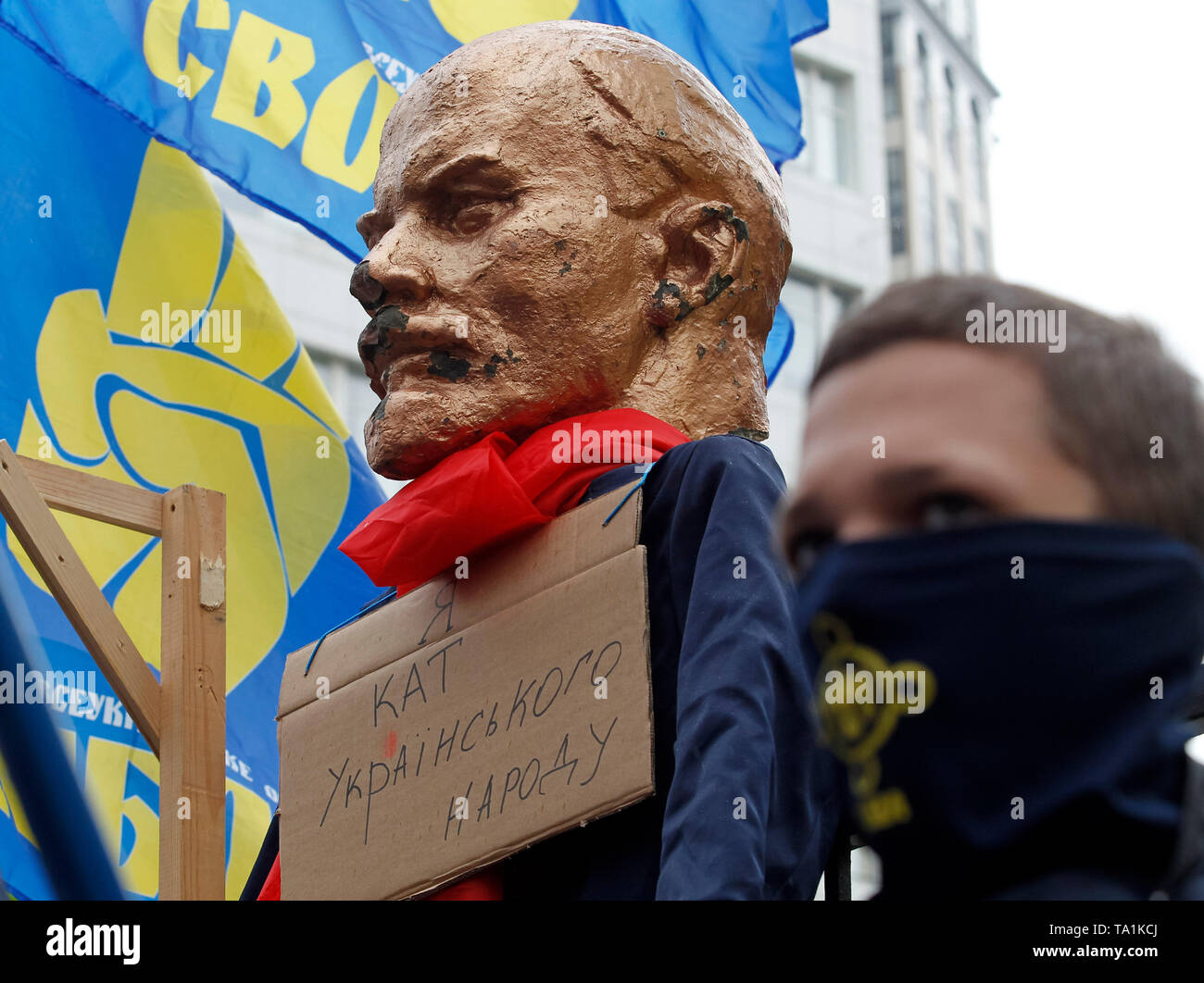 A gallows and a sculpture of the Soviet leader Vladimir Lenin with a placard  saying I am the executioner of the Ukrainian people is seen hanging on a fence of the Constitutional Court during the protest. Protesters stand against appeals of 46 Ukrainian lawmakers who appealed to the court to review the constitutionality of the law about decommunization. The law on decommunization was voted by the Ukrainian Parliament in April 2015, condemning communist and Nazi totalitarian regimes, banning their propaganda and symbolism. According to the law, the symbolic and propaganda of Nazism, National So Stock Photo