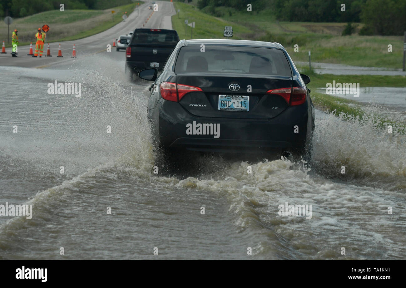 Work crews do traffic control in flooded intersections after Monday
