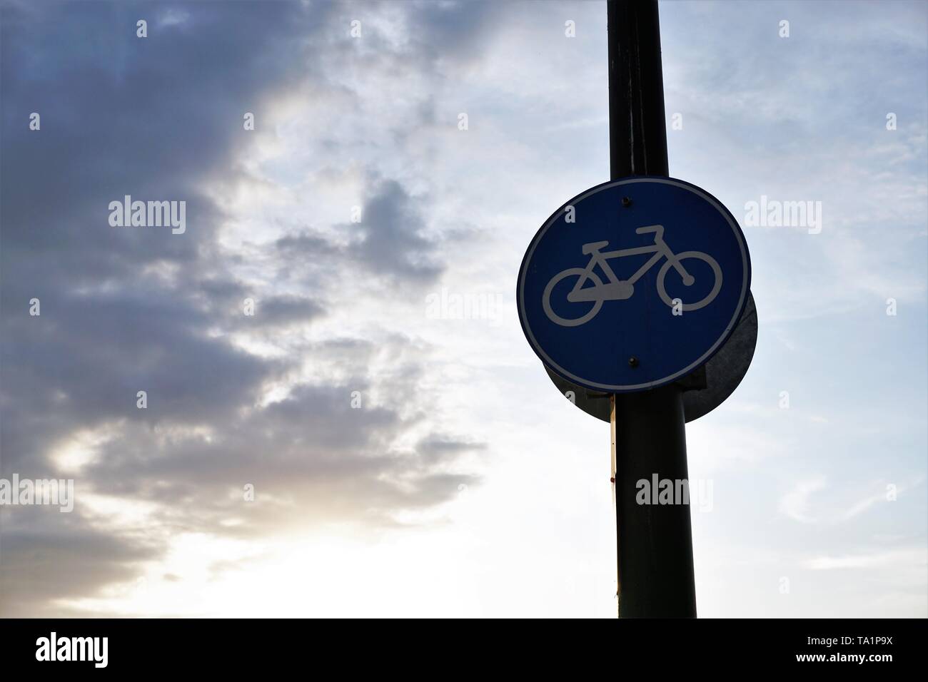Bicycle line road sign with cloudy sky background. Stock Photo