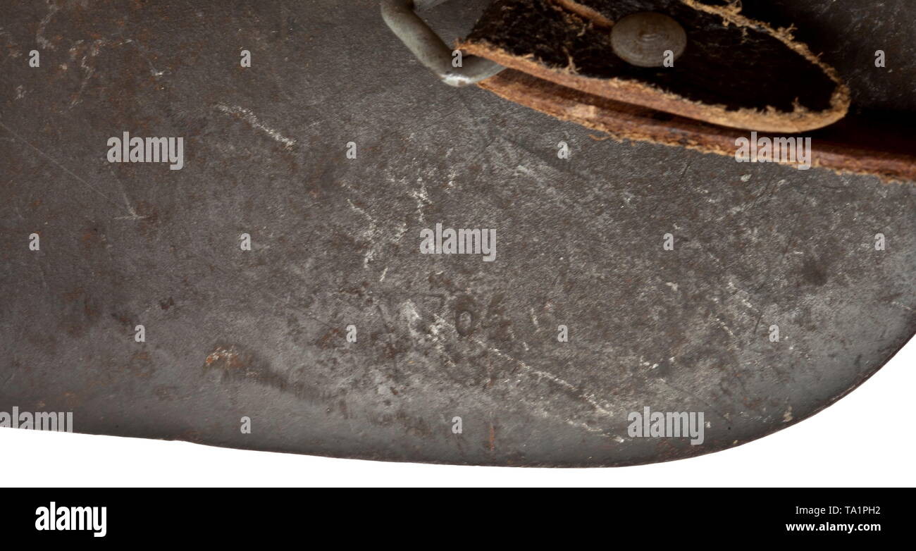 A steel helmet M 42 with chicken wire and later tricolour camouflage with wearer's designation 'Uffz. Sonnabend' Steel skull with struck stamping '1937' (maker illegible, probably 'ET'), tricolor, later camouflage paint, above the chicken wire net to affix camouflage material, the interior with the handwritten wearer designation 'Uffz. Sonnabend'. Complete inner liner with chinstrap. historic, historical, army, armies, armed forces, military, militaria, object, objects, stills, clipping, clippings, cut out, cut-out, cut-outs, 20th century, Editorial-Use-Only Stock Photo