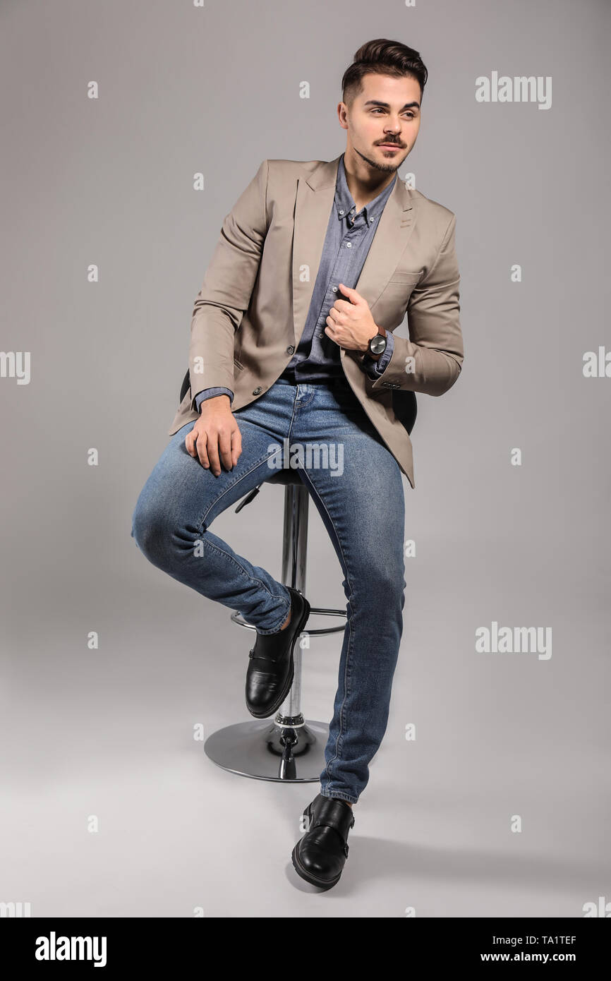 Handsome young man on grey background Stock Photo - Alamy