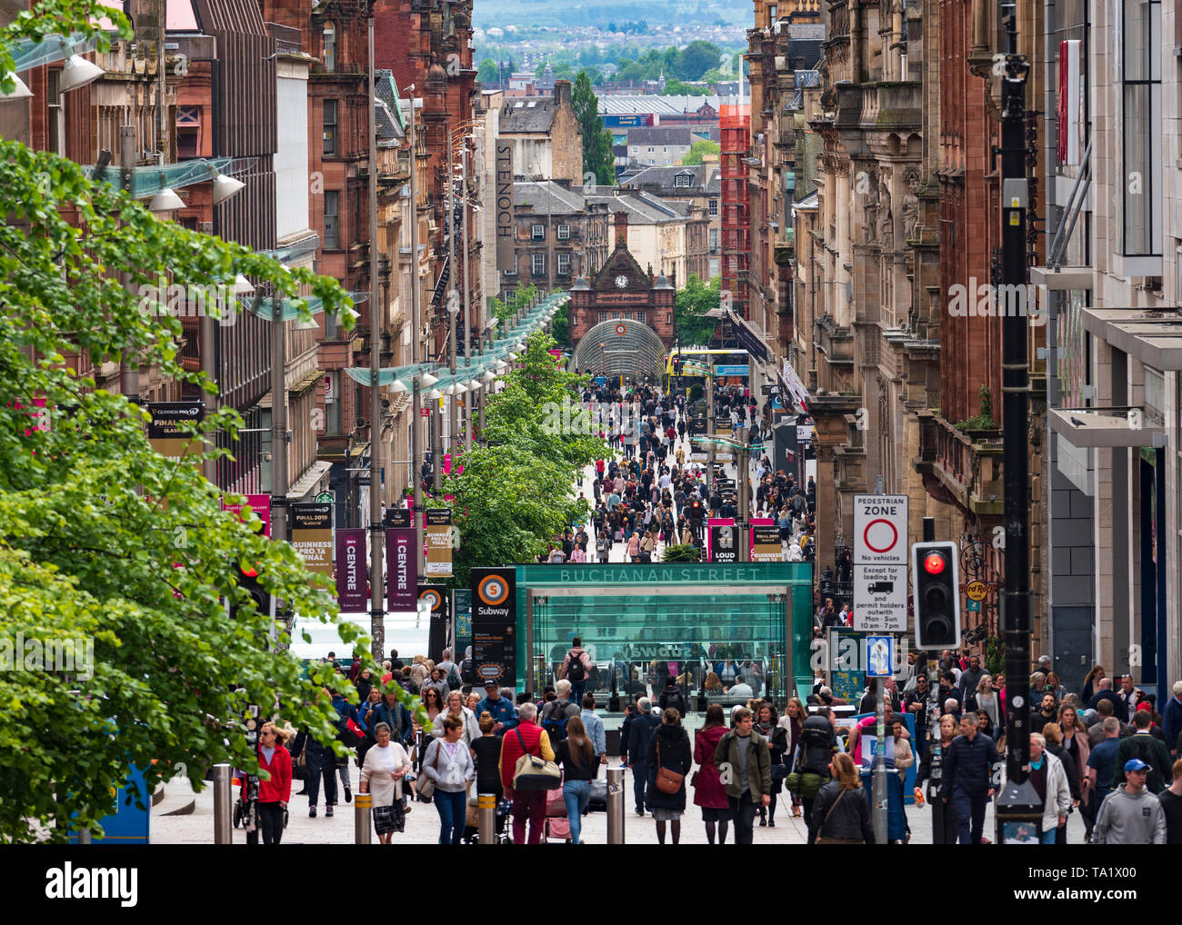 View of shoppers and shops on Buchanan Street the main pedestrian shopping street in Glasgow