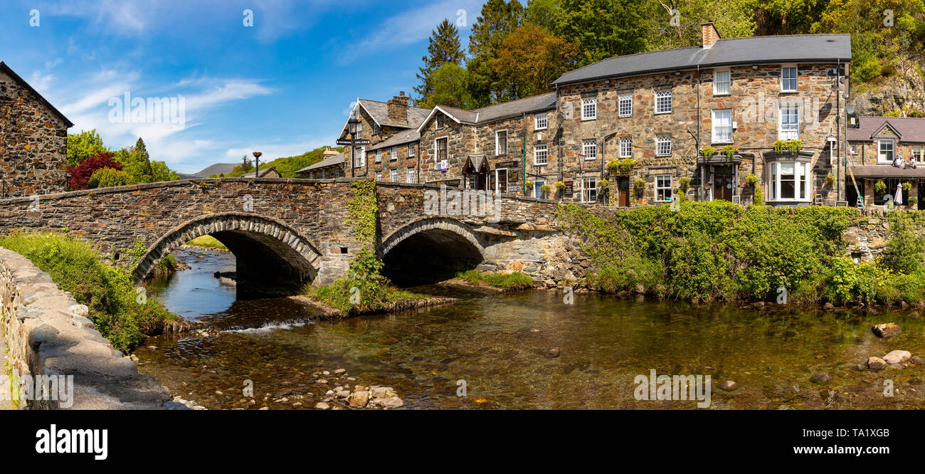 Beddgelert Gwnedd Wales May 13, 2019 Attractive stone buildings beside the river Glaslyn, in Beddgelert, in the Snowdonia National Park Stock Photo
