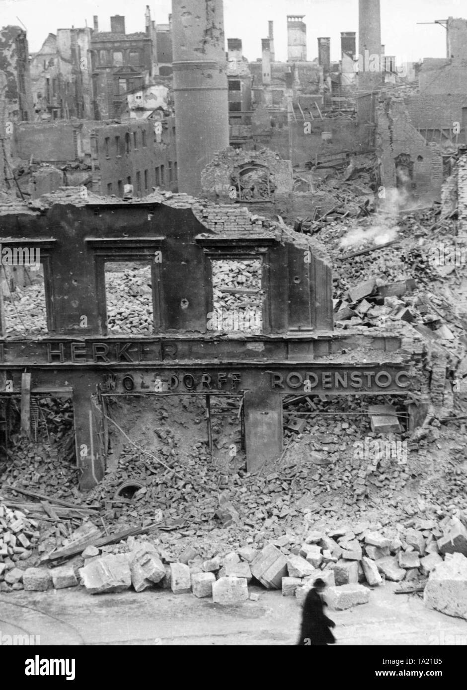 Munich city center destroyed by the Allied air raids in the spring of 1945. In the foreground on the ruins is the inscription 'Herker', 'Wolsdorf' and 'Rodenstock'. Stock Photo