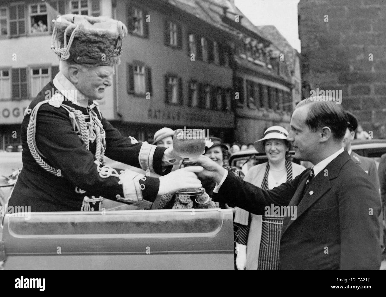 Field Marshal August von Mackensen (left) in a uniform of the Danzig Death's Head Hussars receives a wine cup from the First Mayor. Stock Photo
