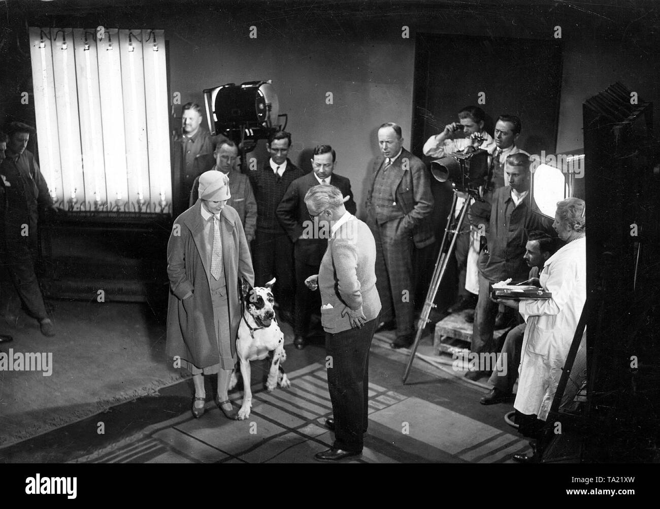 The actress Henny Porten with a dog at the filming of a silent movie in the film studio. Stock Photo