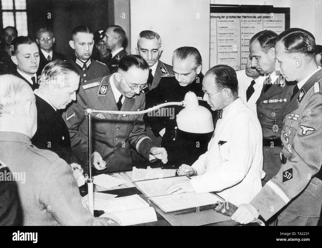Reichsfuehrer-SS Heinrich Himmler (middle) with the Spanish Interior Minister Serrano Suner during a visit to the manuscript collection of the Reich Criminal Police Department. Also thereby front right: Reinhard Heydrich, head of the Security Service (SD), Karl Wolff, Chief of Personal Staff to the Reichsfuehrer, next to Himmler on the right, the Spanish Interior Minister, left behind him, Reich Criminal Director Nebe. Stock Photo