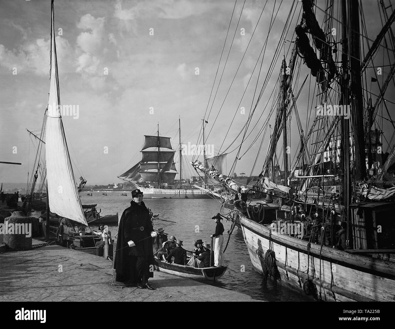 Philips Holmes as Bellini in 'Casta Diva', directed by Carmine Gallone, UK / Italy 1935. A rowing boat takes passengers on board of a large sailing ship before the departure. Stock Photo