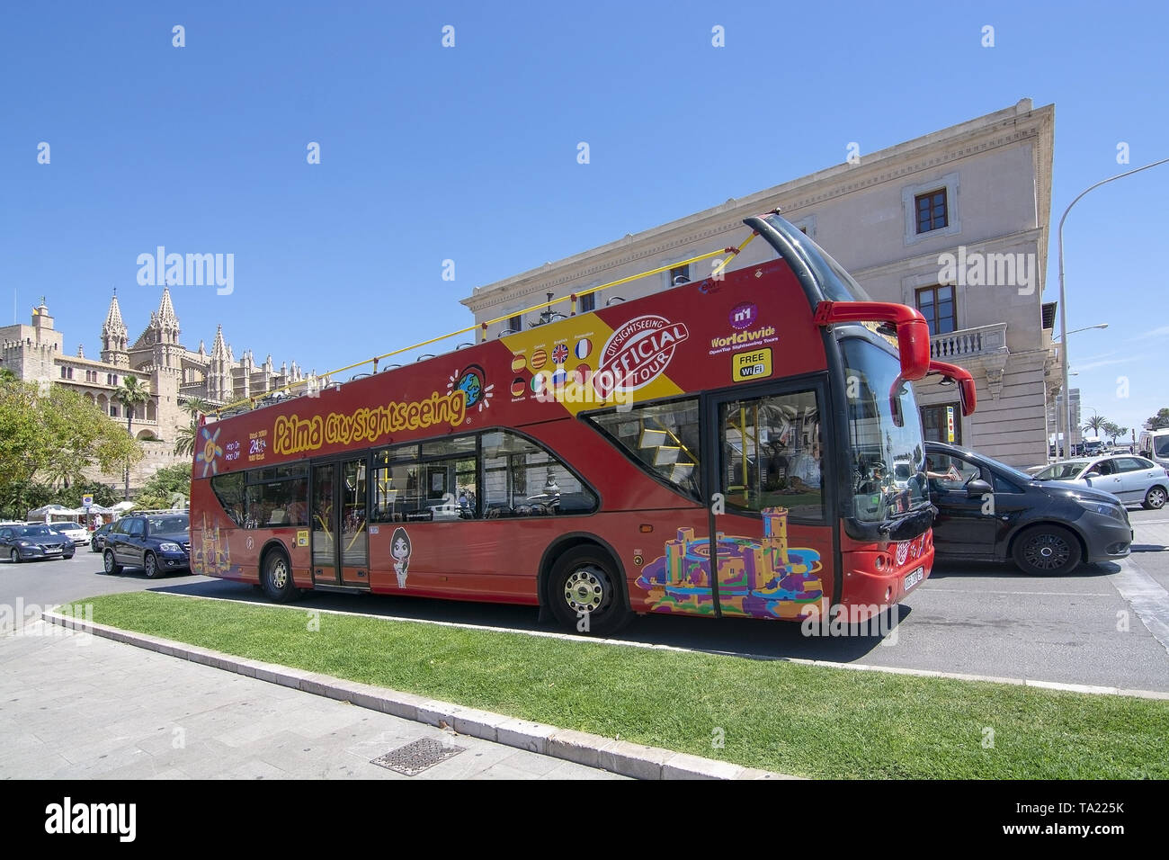 PALMA, MALLORCA, SPAIN - MAY 20, 2019: Hop on hop off tour bus and cathedral  on May 20, 2019 in Palma, Mallorca, Spain. Stock Photo