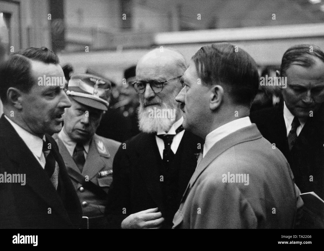 Chancellor Adolf Hitler at the motor show in Berlin talking to representatives of the company Bosch. From left: Director Rassbach, Korpsfuehrer Huehnlein, Robert Bosch, Adolf Hitler and Director Werlin. Stock Photo