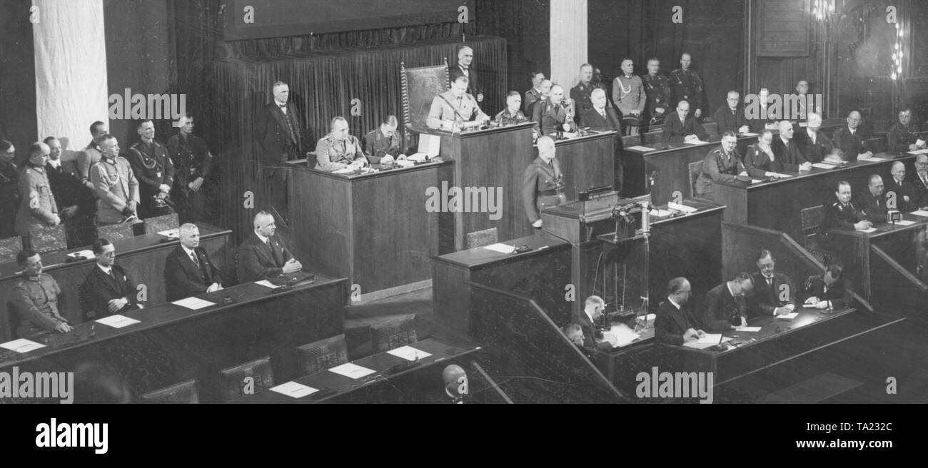 The Nazi Interior Minister Wilhelm Frick (at the lectern) speaks at the opening of the Reichstag in the Berlin Kroll Opera. As president of the Reichstag, Hermann Goering. Stock Photo