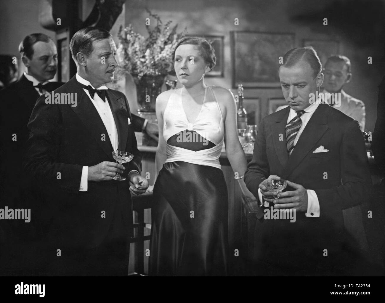 Hans Zesch-Ballot (left), Fritz Odemar as authorized signatory Lissmann, Flockina von Platen as Gina Stern and Heinz Ruehmann as racing cyclist Willy Streblow (right) in the film comedy 'Stroke by the Bill' (German: Strich durch die Rechnung) by Alfred Zeisler. The plot of the film is based on the novel by Fred Antoine Angermayer. Stock Photo