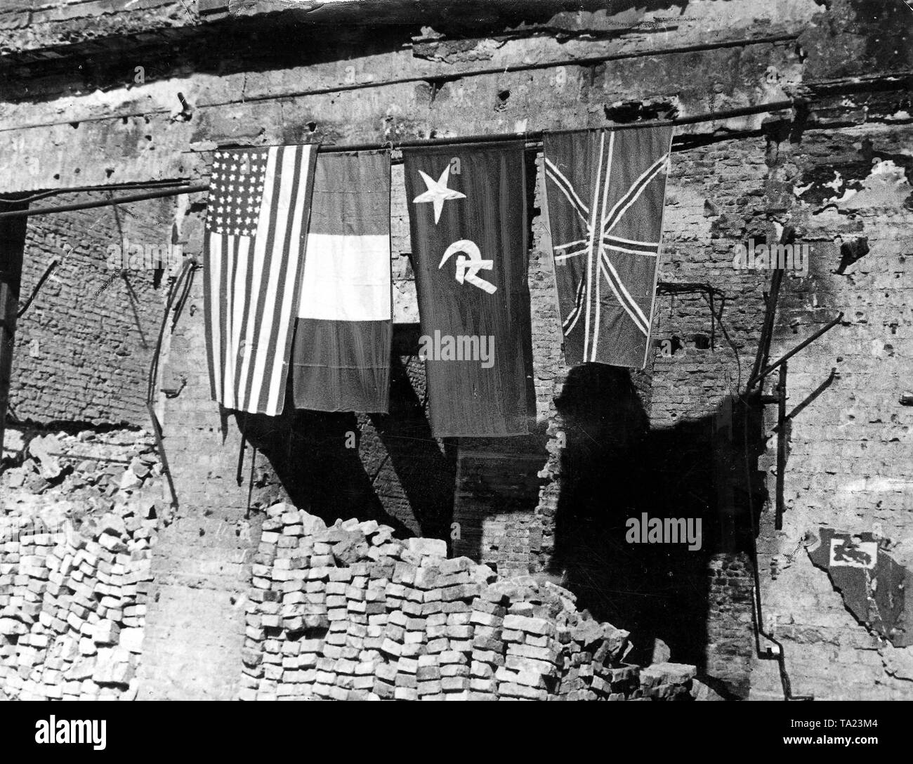 In the ruins of the Reichstag in Berlin hang temporarily the self-made flags of the four victorious powers of World War II. Stock Photo