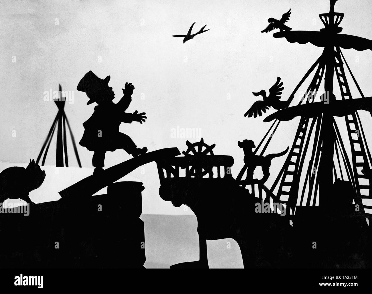 This photo shows a scene from the silhouette film 'Dr. Dolittle and His Animals' - subtitle: 'The Trip to Africa' by Charlotte Reiniger. The silhouette film, also known as silhouette animation, is a technique of animated film in which silhouettes are put together on a lighted glass plate in front of a white or black background to form a film. The result is the silhouette film, inspired by shadow theater and the pictorial techniques of silhouette cutting. Stock Photo