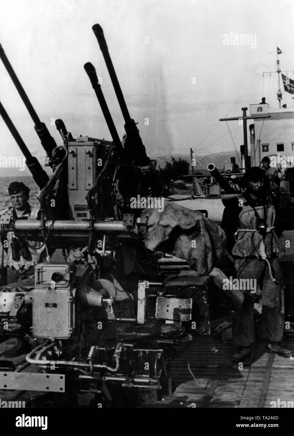 A Flak Vierling 38 (2 cm Flak Vierling 38) on a German warship in the Arctic Ocean. In the background, the Norwegian coast. Photo of the Propaganda Company (PK): war correspondent Maltry. Stock Photo