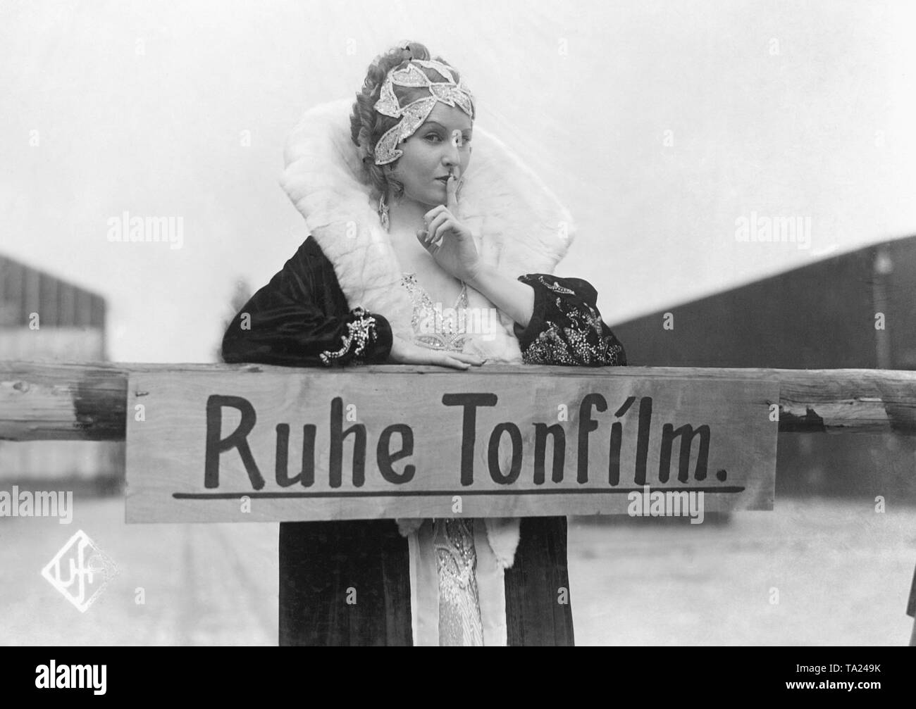 Actress Lilian Harvey demands silence during a sound film shooting with the sign: 'Quiet. Sound film on air'. She was the leading actress of the UFA film 'Once You Give Away Your Heart', a silent movie from 1929, directed by Johannes Guter. The movie was dubbed shortly thereafter. Stock Photo