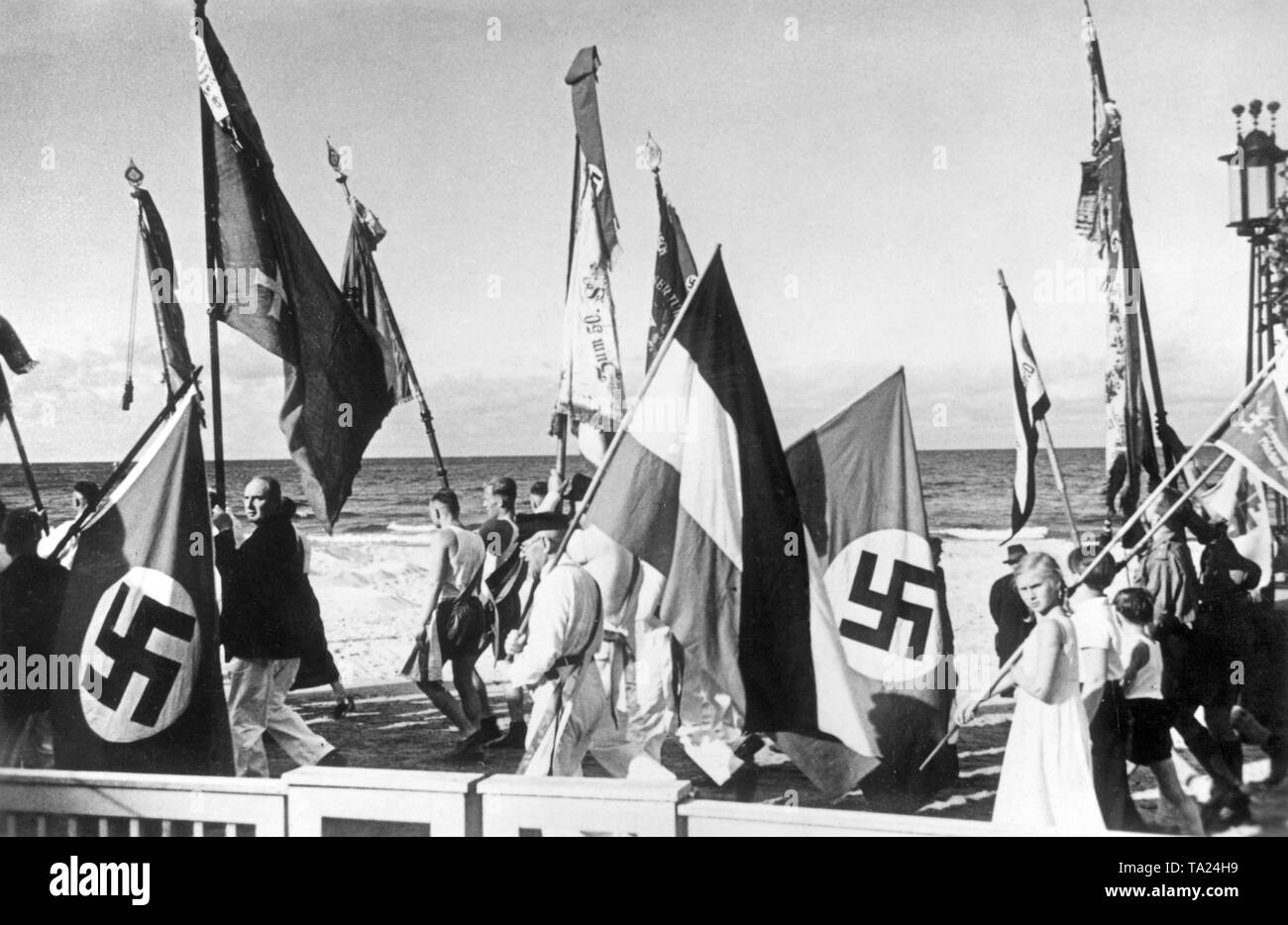 The frontier tournament of the Gaus of East Prussia, Gdansk and Pomerania took place in Gdansk. A National Socialist rally took place at the opening ceremony in the Kurgarten (spa garden) in Sopot. In the photo, the color guards on their way to the rally. Stock Photo