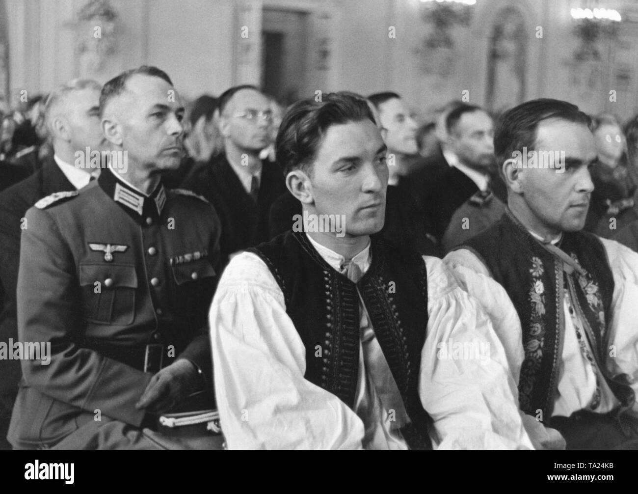 Assembly of the Protectorate of Bohemia and Moravia in Prague. The men wear Sudeten German costumes and uniforms of the Werhmacht. Since March 1939, the areas of Bohemia and Moravia had been under German occupation. Stock Photo