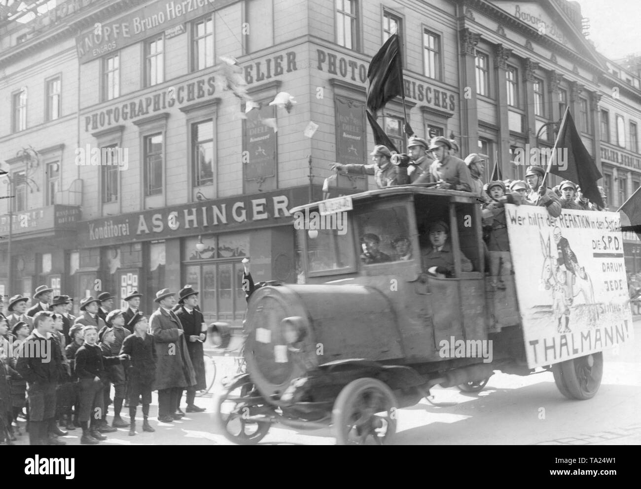 During the presidential election in 1932 an agitation truck of the KPD drives through the streets of Berlin and makes canvassing against the SPD that is hated by the Communists. On the poster on the side of the car, 'Who helps the reaction in the saddle?' The SPD. Therefore all vote for Thaelmann!' Stock Photo