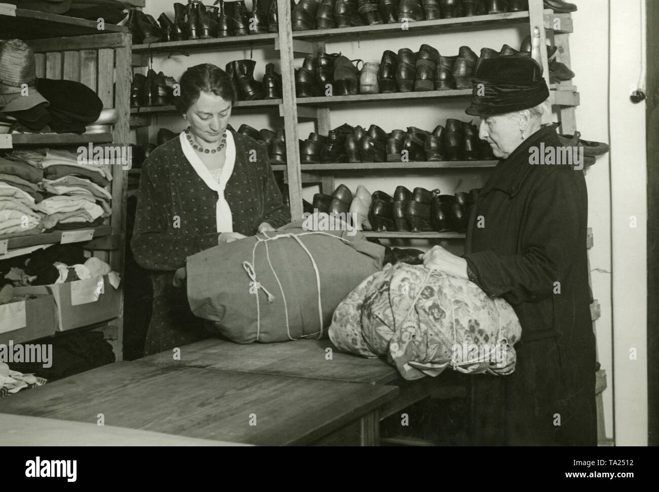 This photograph shows an old woman who collects clothes donations