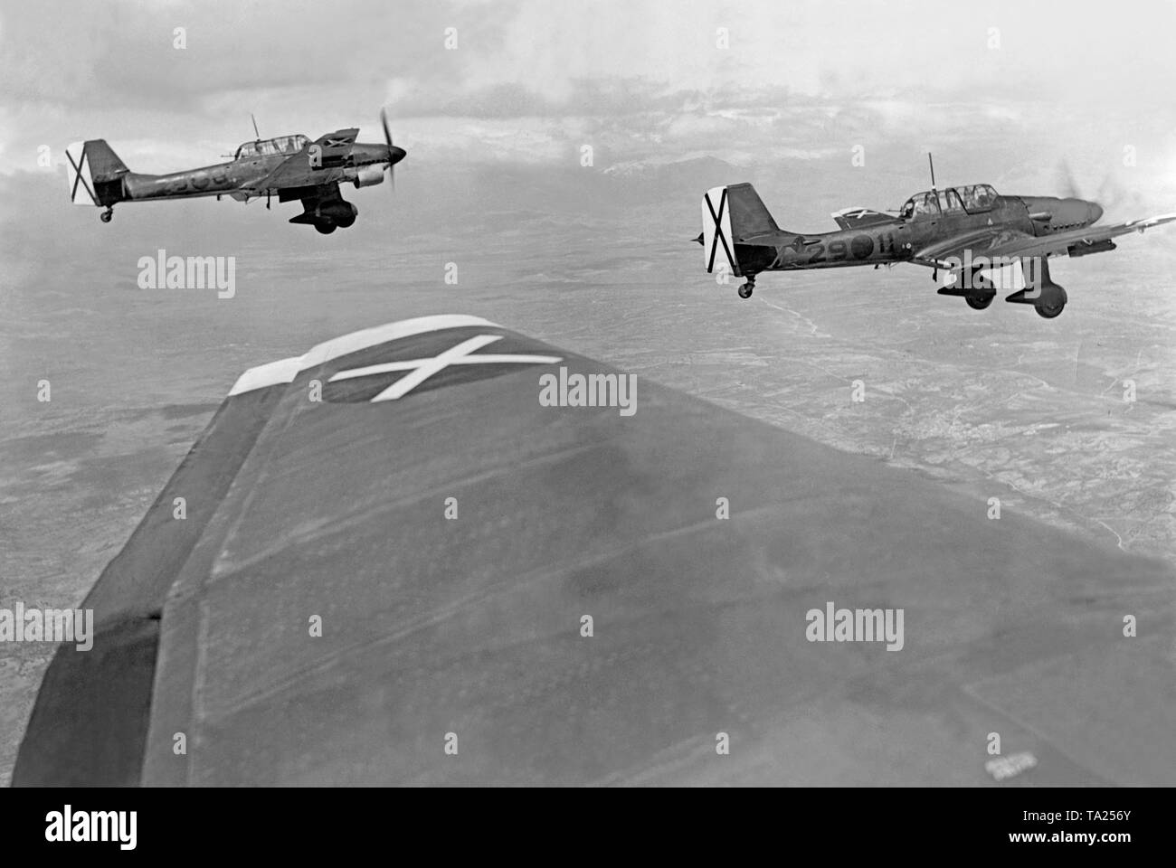 Photo of two German (Stuka) Junker 87 (Ju 87) bombers during their echelon flight on the Brunete Front west of Madrid during the Battle of Brunete in July, 1937. The photo was taken from one of the aircrafts. The cockades of the Condor Legion are well discernable. Stock Photo