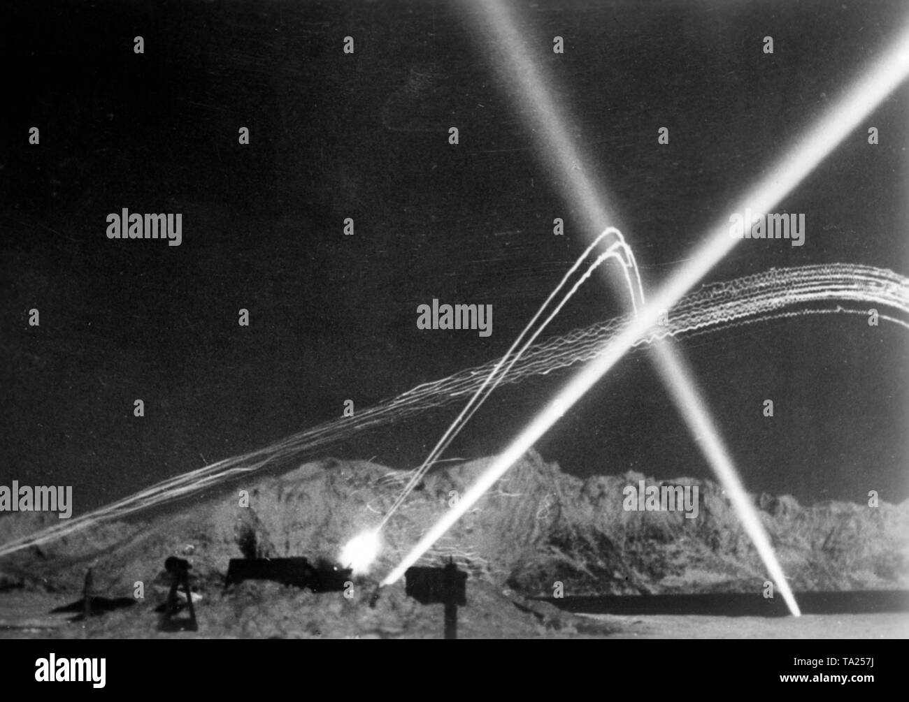 German anti-aircraft cannons shoot with tracer ammunition at attacking Soviet aircrafts. Photo of the Propaganda Company (PK). Stock Photo