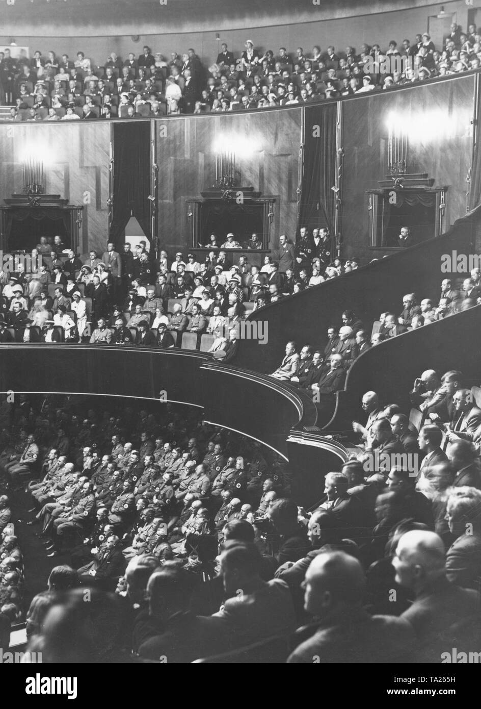 Spectators, including ambassadors in the diplomats' box (center), during a session of the Reichstag on the so-called Roehm Putsch. Stock Photo