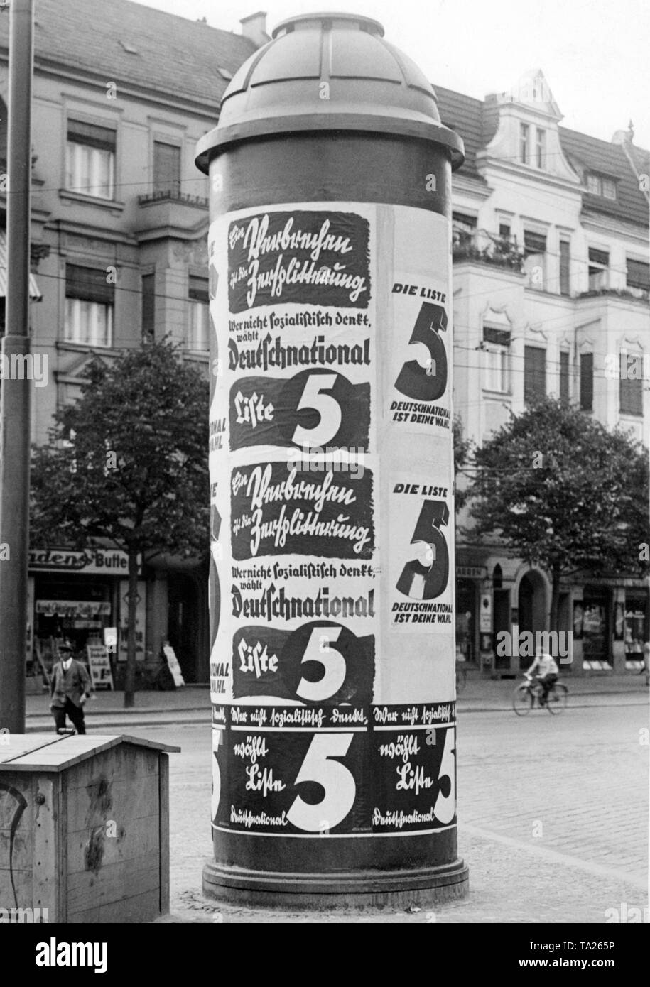 Advertising column at the corner of Ordensmeisterstrasse in Berlin-Tempelhof. This is the canvassing of the German National People's Party for the Reichstag election in 1932. The slogan 'Crime is the split-up' invokes national unity. Stock Photo