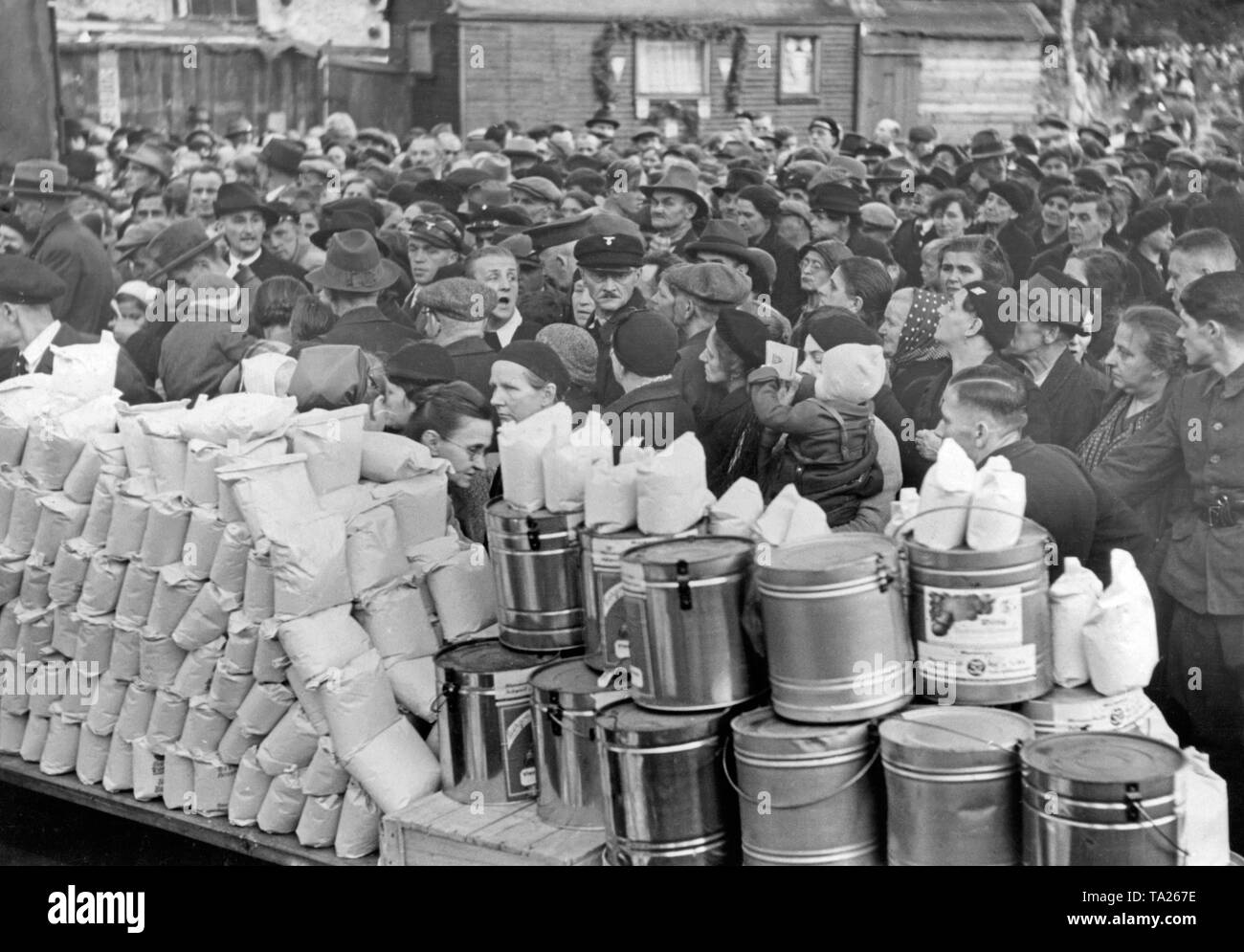 The National Socialist People's Welfare (NSV) distributes food to the population on October 11, 1938, in Reichenberg (today Liberec) after the occupation of the Sudetenland by Germany. Stock Photo