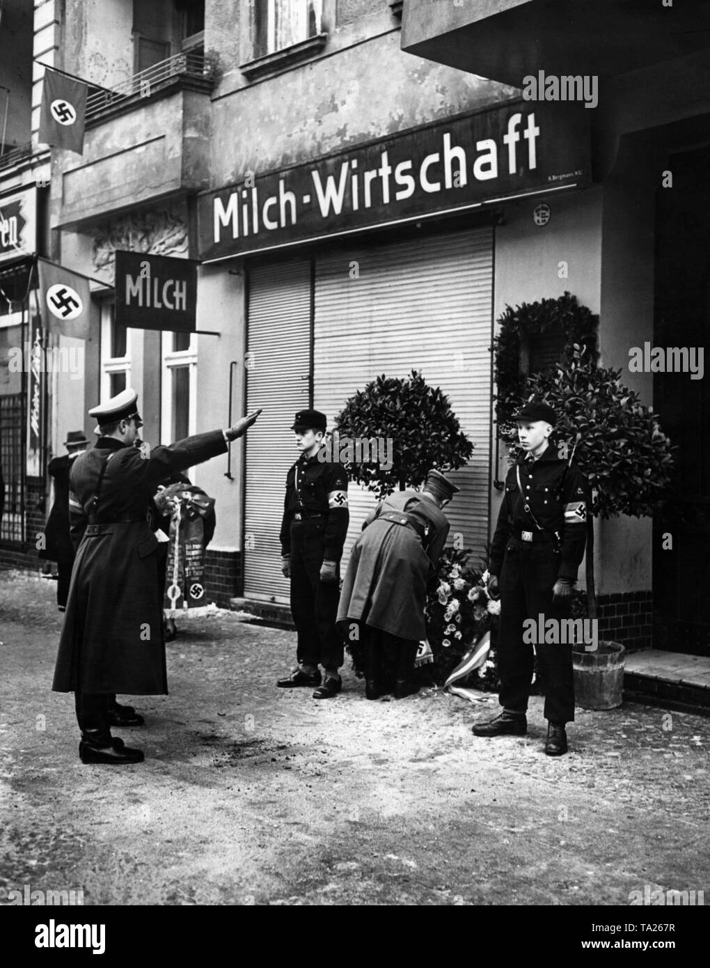 In front of the house in 27 Wagnitzstrasse (now Utrechtstrasse), members of the Hitler Youth are holding guard of honor at the deathplace of Walter Wagnitz, who was murdered on January 1, 1933. The leader of the Berlin HJ, Artur Axmann, is laying a wreath in his memory. Stock Photo