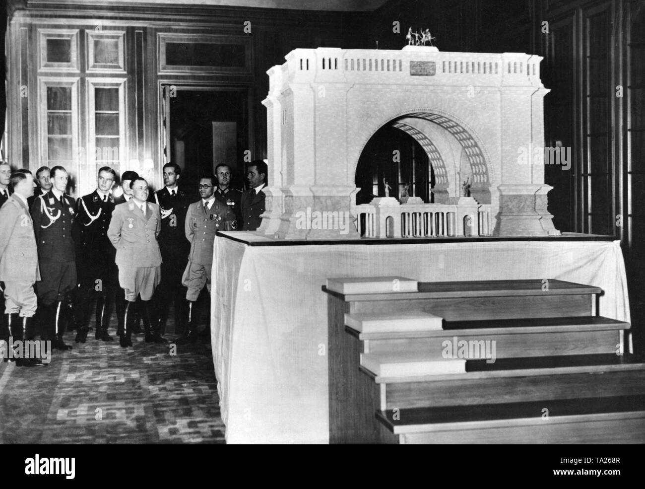 Adolf Hitler and other party functionaries inspect the modell of the triumphal arch, which was planned to be built after the end of the war in Berlin. Undated picture. Stock Photo